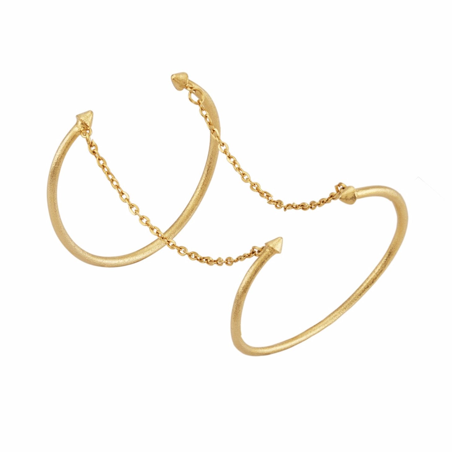 A flexible arm cuff bracelet with a gold and silver finish, featuring a textured handcrafted design.
